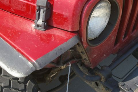 1998 Jeep TJ - This Jeep Wrangler's front corner shows its headlight, fender, and part of the tire.