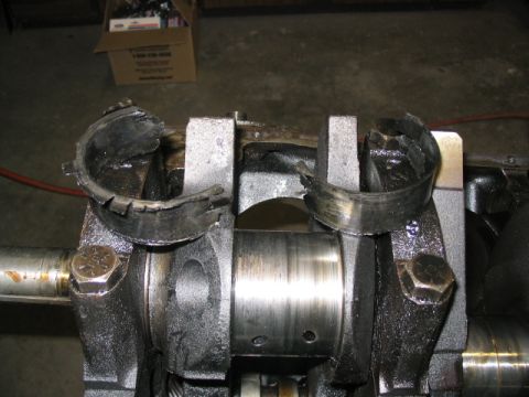 1979 Ford F-150 - Engine crankshaft bearings showing significant damage and wear, indicating a mechanical failure.