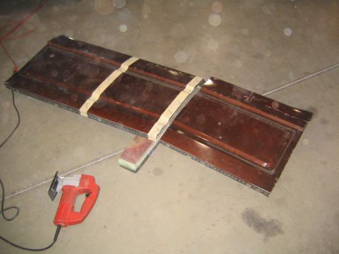 1982 Ford Bronco - Car door panel being worked on with a jigsaw and sanding block.