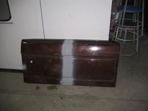1982 Ford Bronco - Car door with primer stripe, possibly for a Ford Bronco, stored indoors.