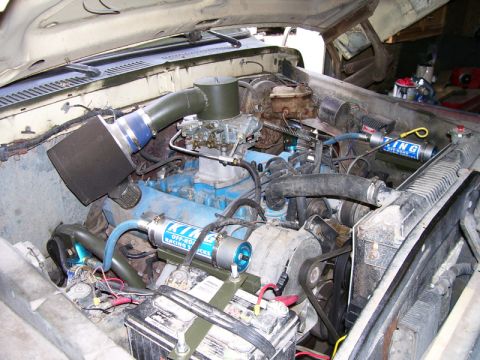 1979 Ford Bronco - The engine bay shows a modified setup with custom parts and visible branding on a shock absorber.