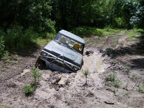 1979 Ford Bronco - This vehicle is stuck deep in the mud on a wooded trail.
