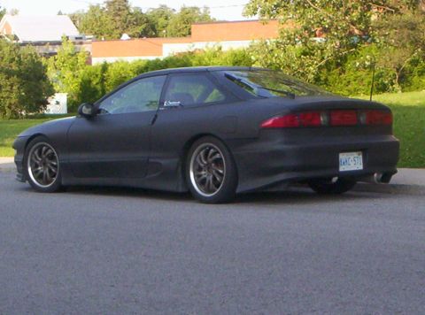 1993 Ford Probe - Rear view of a matte black 1993 Ford Probe with custom wheels and aftermarket exhaust.