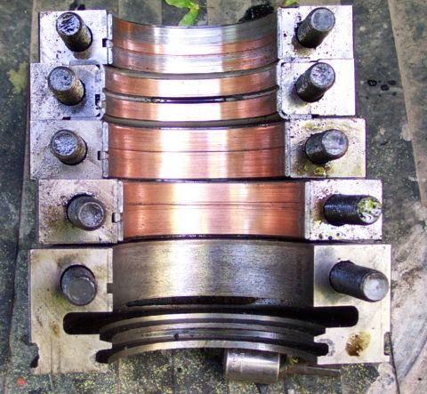 1979 Ford F-150 - Engine bearing caps and a crankshaft pulley are shown in this close-up view.