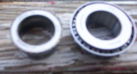 1978 Ford Bronco - Two wheel bearings are shown on a wooden surface.