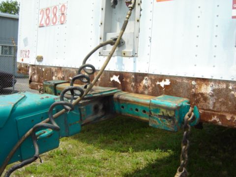 1992 Ford Bronco - Close-up of a trailer hitch and coupling mechanism, showing coiled lines and a numbered trailer.