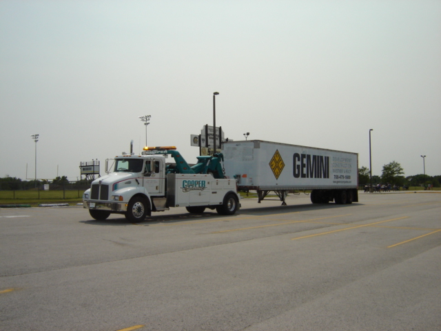 Tow truck towing a Gemini trailer