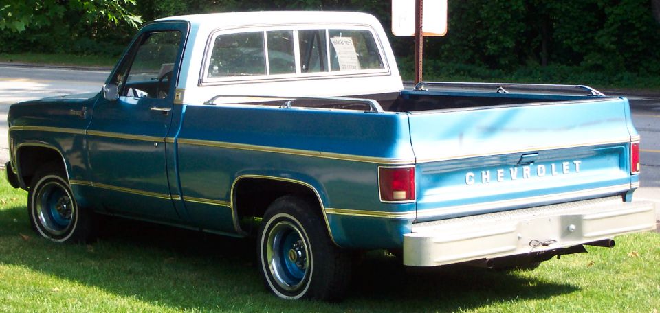 Rear view of a blue and white Chevrolet pickup truck, likely from the 1970s