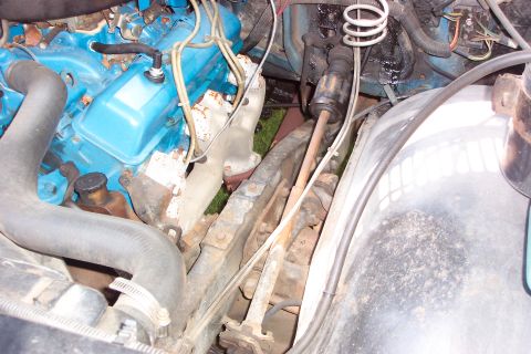 1979 Ford F-150 - Close-up view of an engine bay, showing blue valve covers and various hoses and mechanical parts.