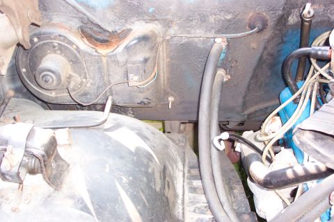 1979 Ford F-150 - This image shows various components within a vehicle's engine bay, including hoses and wiring.