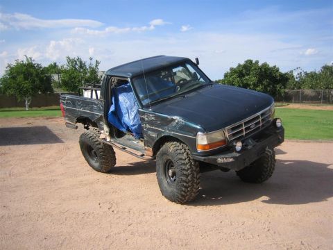 1994 Ford Bronco - This modified Ford F-Series truck features a lifted suspension and oversized tires.
