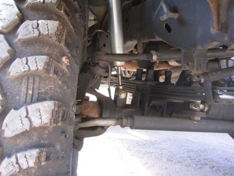 1994 Ford Bronco - Close-up view of the suspension and tire of an off-road vehicle.