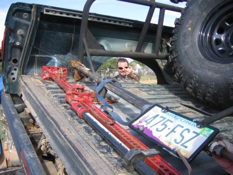 1994 Ford Bronco - A man in a 1994 Ford Bronco gives the camera the middle finger while a Hi-Lift jack is visible in the bed.