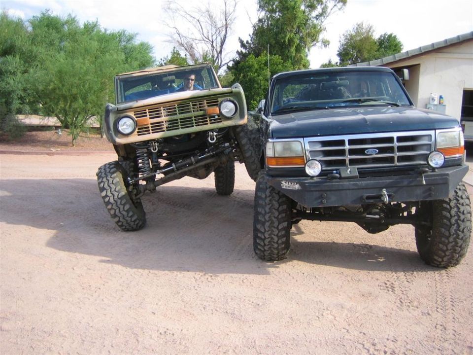 Camouflaged Bronco and dark blue 1994 Ford Bronco front view