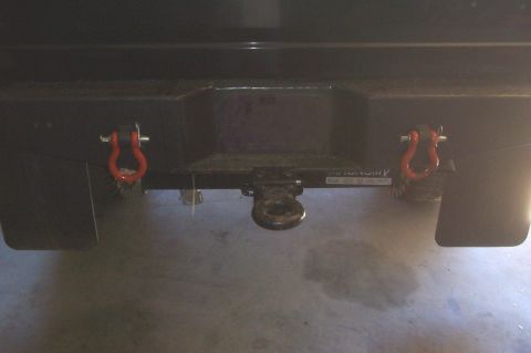 1994 Ford F-150 - Rear view of a vehicle's bumper, a tow hitch and two red tow hooks.