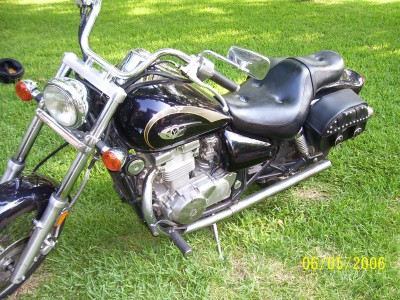 1972 Ford Ranchero - A motorcycle with a black fuel tank and seat is shown from the front-right side on a grassy lawn.