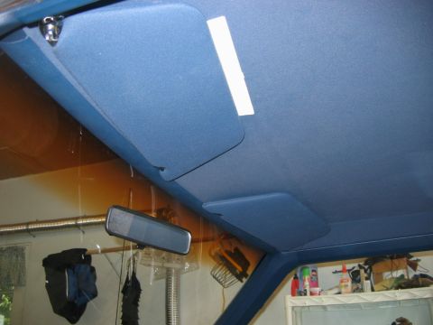 1985 Ford LTD Crown Victoria - The blue interior of a vehicle, focusing on the headliner and sun visors.