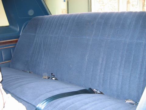 1985 Ford LTD Crown Victoria - Interior view of a blue velour rear seat with seatbelts.