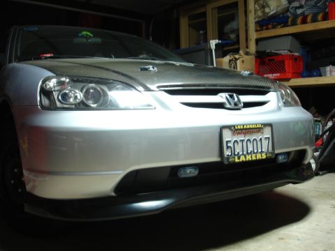 1993 Ford Taurus - Silver Honda Civic with carbon fiber hood and custom headlights parked in a garage.