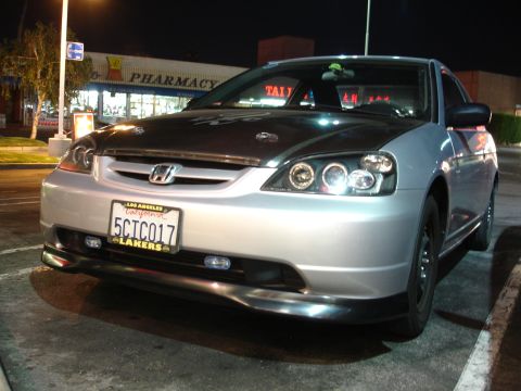1993 Ford Taurus - This silver Honda Civic features custom headlights and a carbon fiber hood, with a California license plate visible.