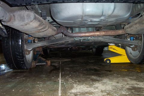 1995 Ford Taurus - The underside of a vehicle is shown, with the exhaust system and rear suspension components clearly visible.