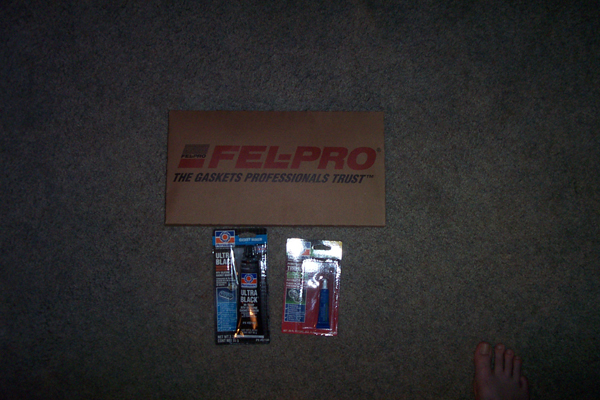 Box of Fel-Pro gaskets and two tubes of sealant on carpet
