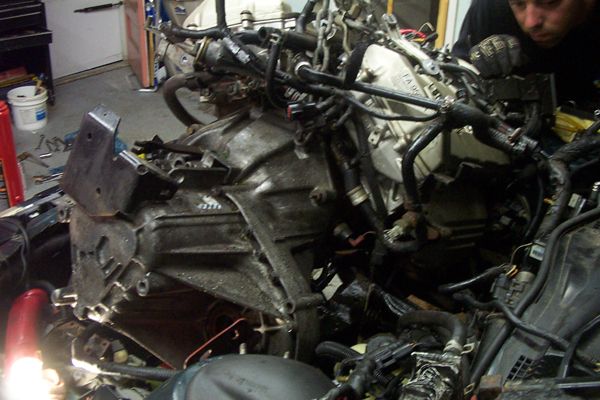 engine and transmission out of a car, being worked on