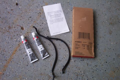 1995 Ford Taurus - The image displays automotive parts including sealant tubes, a hose, and a boxed component, along with an instruction manual.