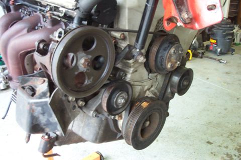 1995 Ford Taurus - Close-up view of an engine assembly, showing various components and belts.