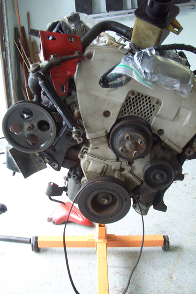 1995 Ford Taurus - Engine assembly mounted on an orange stand, ready for service or replacement.