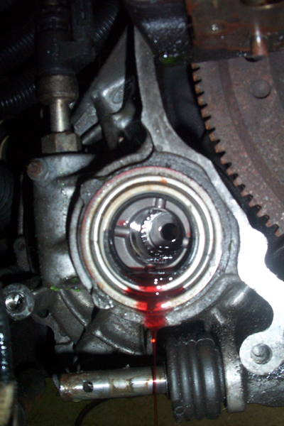 1995 Ford Taurus - Engine part showing a leak of red fluid from a central opening.