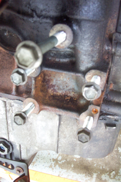 1995 Ford Taurus - Close-up view of an engine block, showing bolts and mounting hardware. The registry claims a 1995 Ford Taurus.
