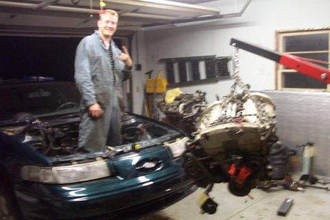 1995 Ford Taurus - Engine removal in progress for a 1995 Ford Taurus.
