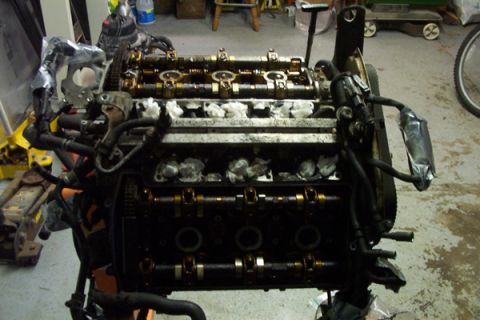 1995 Ford Taurus - Engine assembly on a stand, ready for refresh or swap, with visible camshafts and valve train components.
