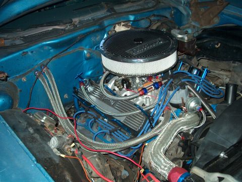 1978 Ford Ranchero - Close-up view of a V8 engine with custom modifications, including an aftermarket air cleaner and braided hoses.