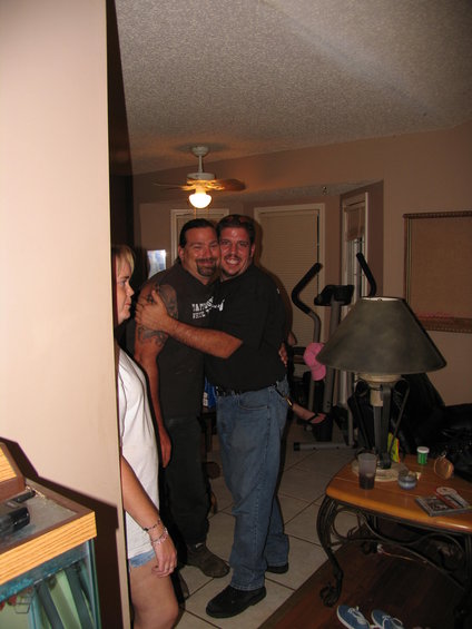 1995 Ford Bronco - Two men embrace in a room with exercise equipment and a lamp visible in the background.