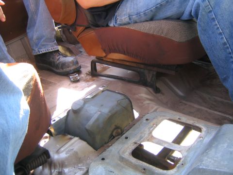 1982 Ford Bronco - Interior view of a vehicle, showing the floor and seat bases with people seated.