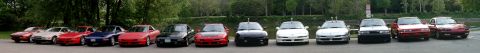 1995 Ford Probe - A row of various cars are parked in a line, all facing forward.