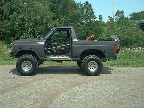 1986 Ford Bronco - This modified Ford Bronco, likely from the early 1980s, is shown from the side with its doors removed.
