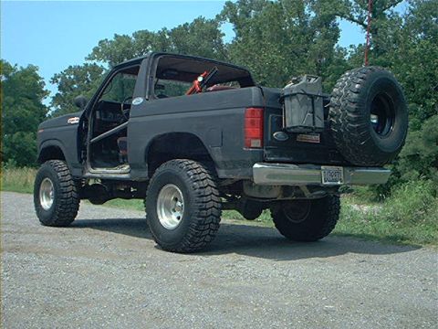 1986 Ford Bronco - This modified Ford Bronco has a lifted suspension and off-road tires, suggesting an earlier model year than claimed.