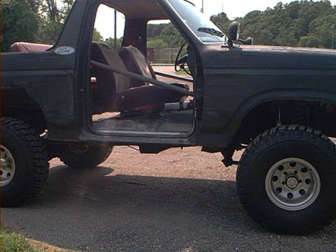 1986 Ford Bronco - This 1986 Ford Bronco is shown with its doors removed, revealing a roll cage and interior.