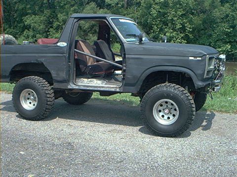 1986 Ford Bronco - This lifted 1986 Ford Bronco is shown with its doors removed, highlighting its off-road modifications.
