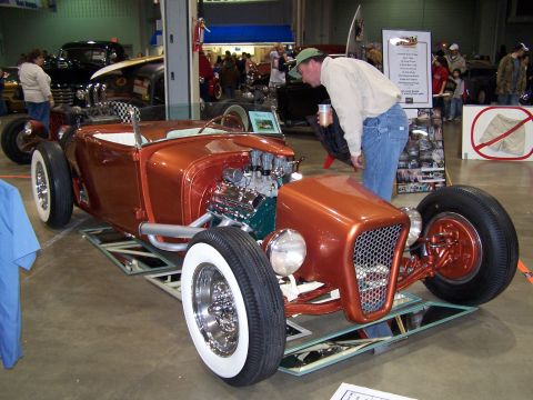 1995 Ford Probe - Custom hot rod on display with a man looking at the engine.