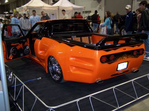 1995 Ford Probe - This heavily modified pickup truck is displayed indoors with its driver's door open.