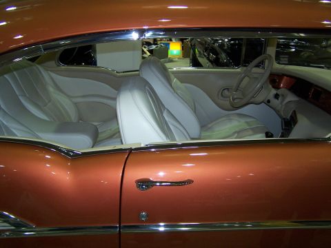 1995 Ford Probe - The interior of a classic car features custom white leather seats and a unique dashboard design.
