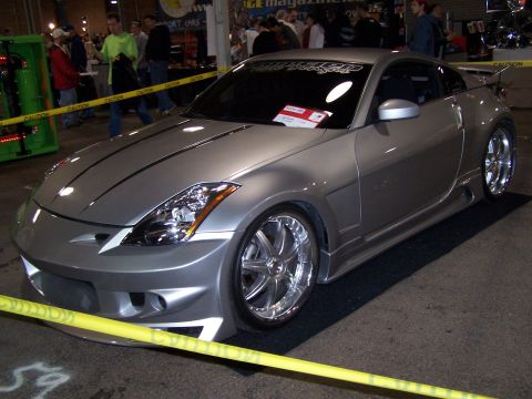 1995 Ford Probe - Modified silver sports car on display at an indoor event.