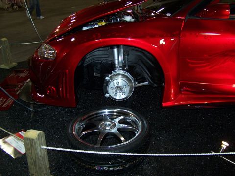 1995 Ford Probe - Custom red car on display, front wheel removed to show brake assembly.