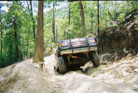 1988 Ford Bronco - This vehicle is tackling a challenging off-road course with steep inclines and rocky terrain.