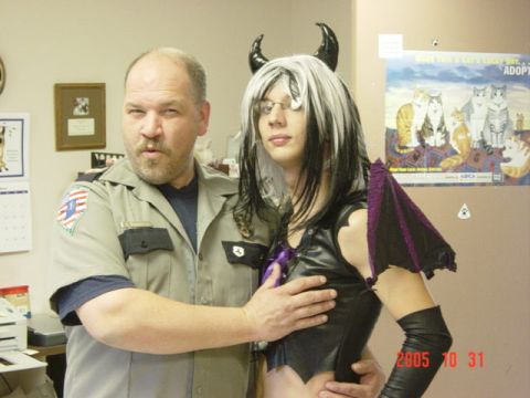 1995 Ford Probe - Two individuals pose for a photo, one in a uniform and the other in a devil costume with horns and wings.