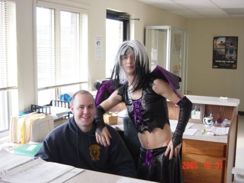 1995 Ford Probe - Two people pose for a photo in an office setting, one dressed in a costume.